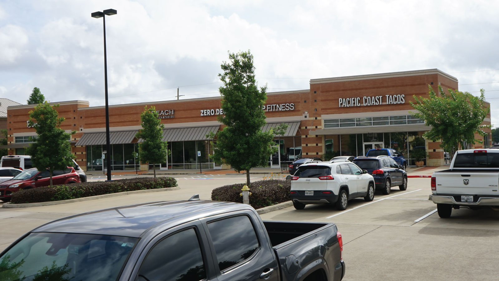 Lake Pointe Village East | Parking and retail structure backs up to Oyster Creek.